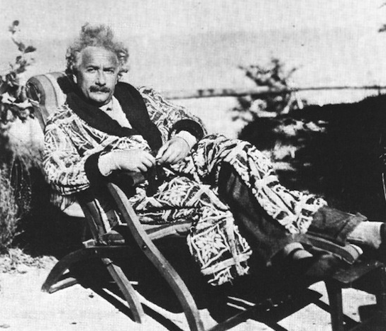 Albert Einstein relaxing in a large bath robe.